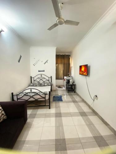 a living room with a bed and a couch at Mlimani city studio apartment in Dar es Salaam