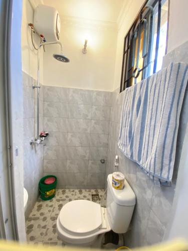 a small bathroom with a toilet and a shower at Mlimani city studio apartment in Dar es Salaam