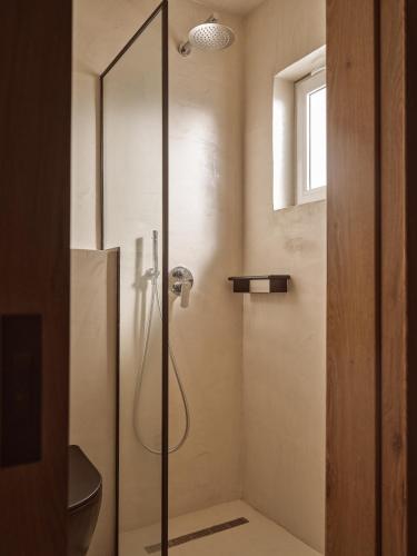 a shower with a glass door in a bathroom at Sanpiero Island in Laganas