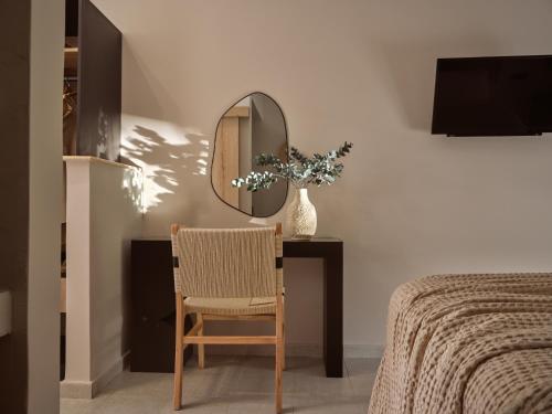 a bedroom with a table with a chair and a mirror at Sanpiero Island in Laganas