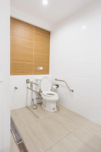 a bathroom with a toilet in a room at Nitichai place, Cozy 3-Storey Sukhumvit Stay in Bangkok