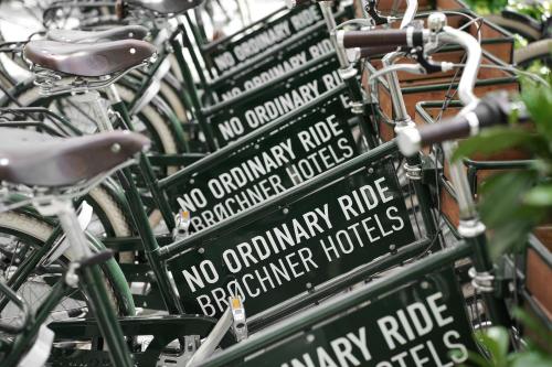 a row of green bikes parked next to each other at Hotel Hans in Copenhagen