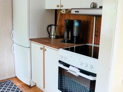 a kitchen with a white stove top oven next to a refrigerator at 5 person holiday home in MELLBYSTRAND-By Traum in Mellbystrand