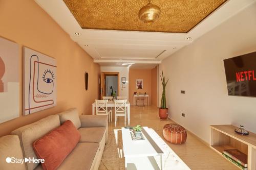 a living room with a couch and a table at Stayhere Rabat - Hassan - Authentic Residence in Rabat