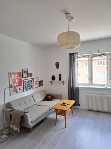 a living room with a couch and a table at Casa Rosenhoff in Oslo