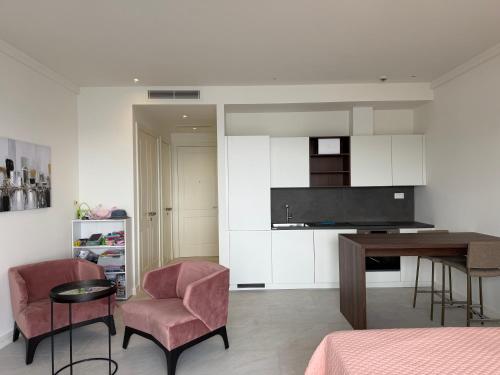 a living room with a table and two chairs at Unique Seaview Studio - Marina Village in Radovići