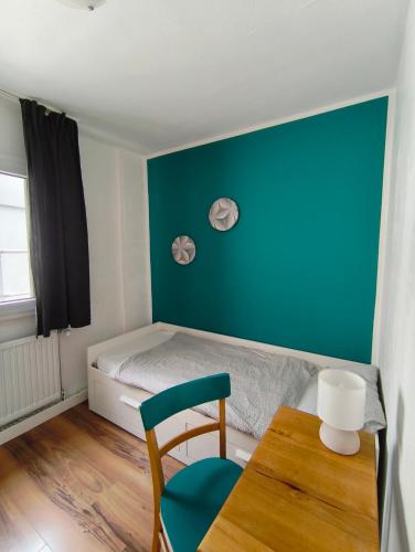 a bedroom with a bed and a table and a chair at Hostel 45 in Bonn