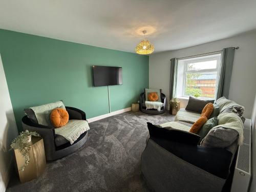 a living room with two couches and a flat screen tv at Duke's Retreat - 4 BR Sleeps 8 Ideal 4 Contractors in Consett