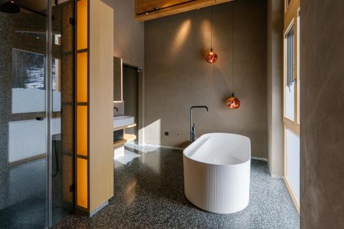 a bathroom with a white tub in the middle of the room at Bergchalet Gastein in Dorfgastein