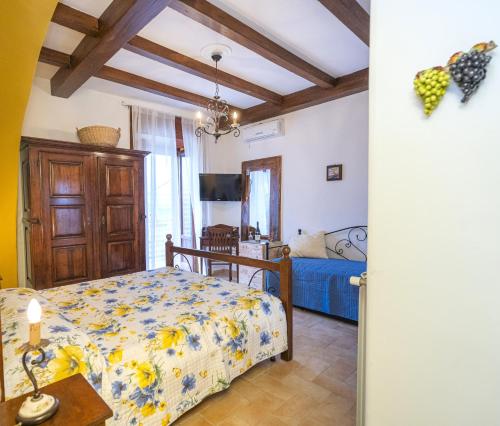 a bedroom with a bed and a table in a room at Tramonti Divini - Amalfi Coast Country House in Tramonti