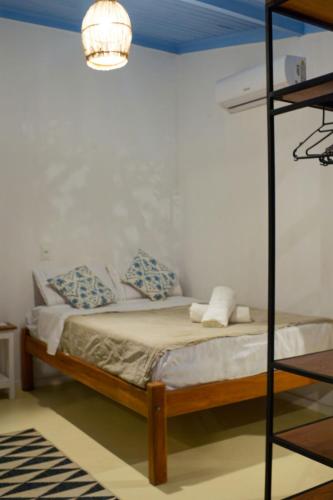 a bedroom with a bunk bed and a lamp at Vila Maré, vista panoramica do mar in Itacaré