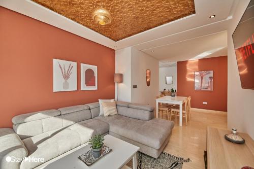 a living room with a couch and a table at Stayhere Rabat - Hassan - Authentic Residence in Rabat