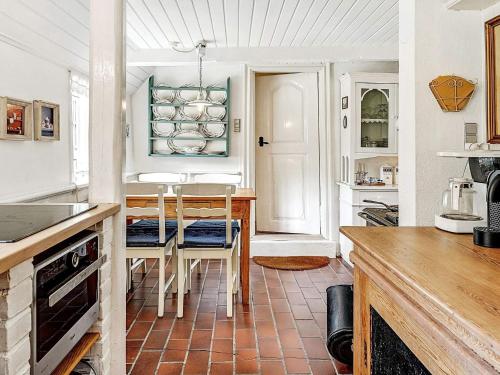a kitchen with a table and chairs in a room at 4 person holiday home in Tønder in Tønder