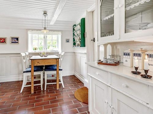 a kitchen with a table and chairs in a room at 4 person holiday home in Tønder in Tønder