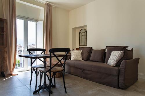 a living room with a couch and a table and chairs at FEDERICO Bed and Wellness in Capestrano