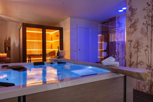a large bathroom with a large blue tub at FEDERICO Bed and Wellness in Capestrano