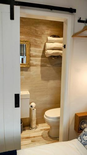 a bathroom with a toilet and some towels at Ropewalk Cottage - A Little Treasure By The Coast in Portaferry