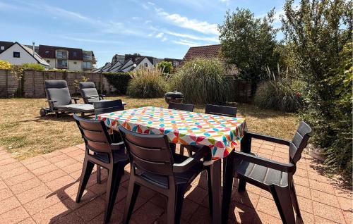 ein Tisch mit Stühlen und ein Tischtuch auf einer Terrasse in der Unterkunft 3 Bedroom Beautiful Home In Bredene in Bredene