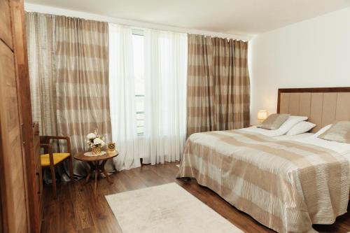 a hotel room with a bed and a window at Edemus - Motel & Restaurant in Maglaj