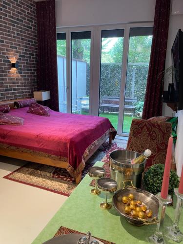 a bedroom with a bed and a table with a bowl of food at Caro’s Gartenwohnung in Vienna