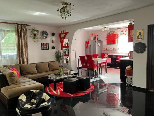 a living room with a couch and a table at Cabana Acasa la Delia in Gîrda de Sus