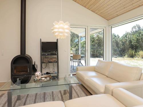 a living room with a couch and a glass table at 8 person holiday home in Ålbæk-By Traum in Ålbæk