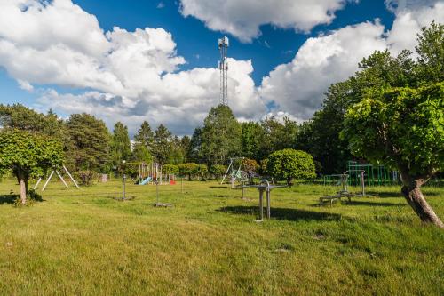an empty park with a playground in a field at Rewita Rogowo k Kołobrzegu in Rogowo