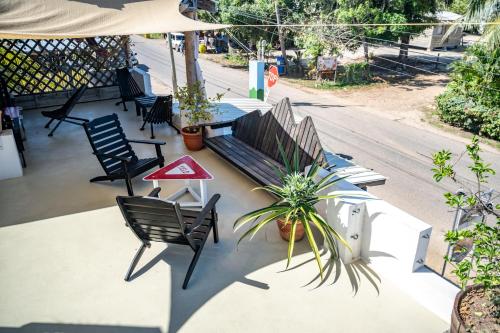 a patio with a bench and a table and chairs at Crash Pad Adventure Hostel in Hopkins