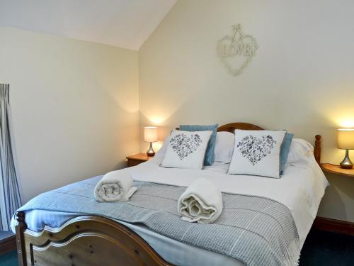 a bedroom with a bed with towels on it at Ardennes Cottage in Sewerby