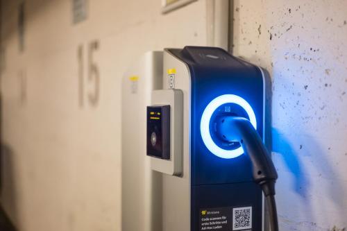 a blue and white gas pump next to a wall at MEININGER Hotel Hamburg City Center in Hamburg