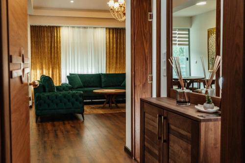 a living room with a green couch and a table at Edemus - Motel & Restaurant in Maglaj