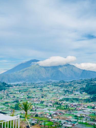 a view of a city with a mountain in the background at Pinggan Campside Glamping in Baturaja