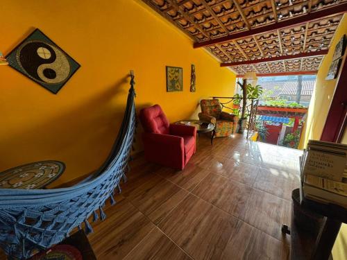 a living room with a hammock in a room at Pousada Leão in Maceió