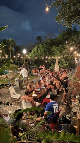 a large group of people sitting at tables at night at Castelo dos Tucanos Host in Rio de Janeiro