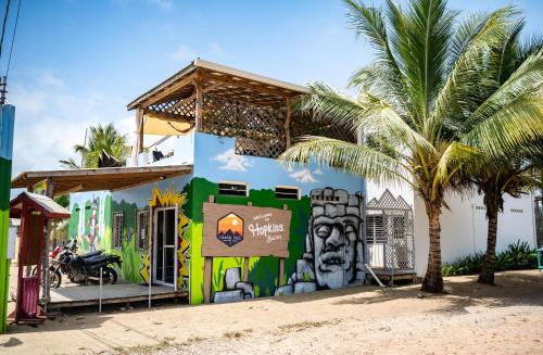 a building with a mural on it with a palm tree at Crash Pad Adventure Hostel in Hopkins