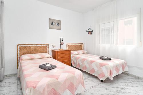 two beds sitting next to each other in a room at Aurora Mar Del Sol in Almuñécar