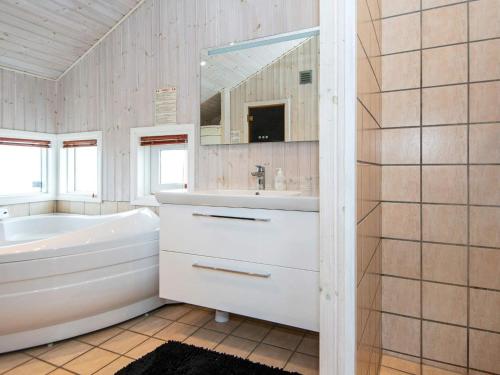 a white bathroom with a tub and a sink at 6 person holiday home in Nordborg-By Traum in Nordborg