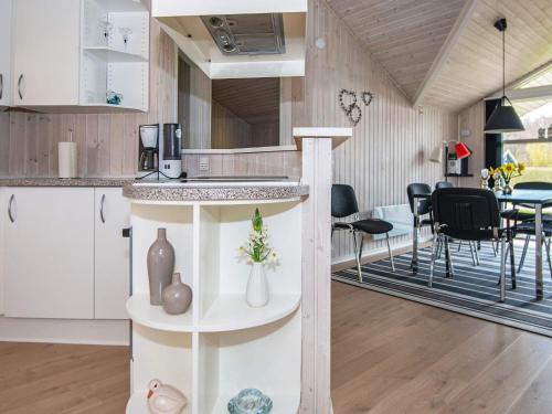 a kitchen and dining room with a table and chairs at 6 person holiday home in Nordborg-By Traum in Nordborg