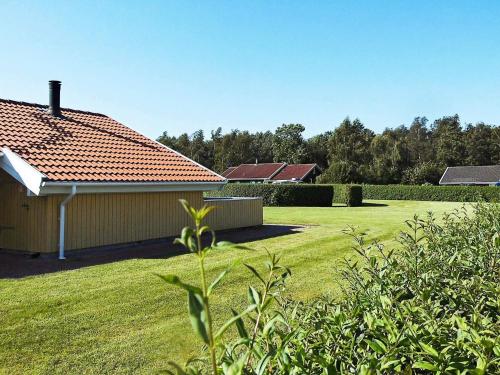 a house in a yard with a grass field at 6 person holiday home in Nordborg-By Traum in Nordborg