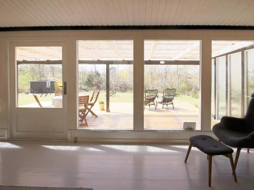 a living room with sliding glass doors and a patio at 4 person holiday home in Jægerspris in Jægerspris