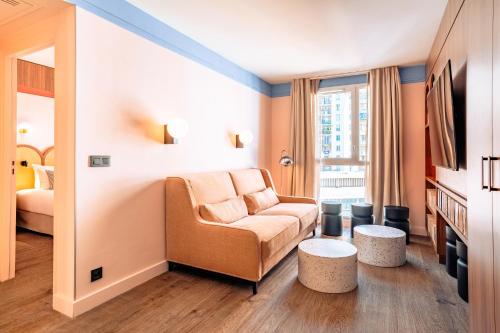 a hotel room with a couch and a bed at RockyPop Marseille Hôtel in Marseille
