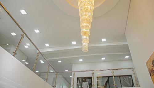 a chandelier hanging from the ceiling in a building at Emirates Hotel in Ondangwa