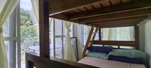 a bunk bed in a room with a window at Kikay's Bed & Breakfast in Tagaytay