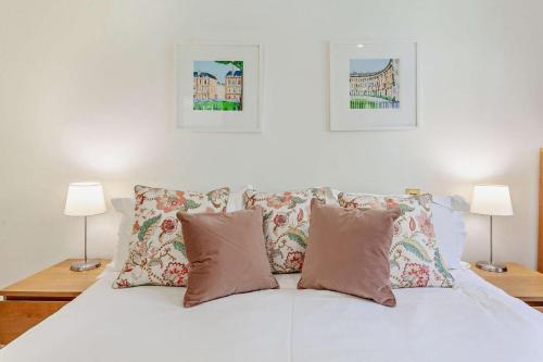 a white bed with four pillows and two lamps at 2 Bed in Bath oc-bhr16 in Bath