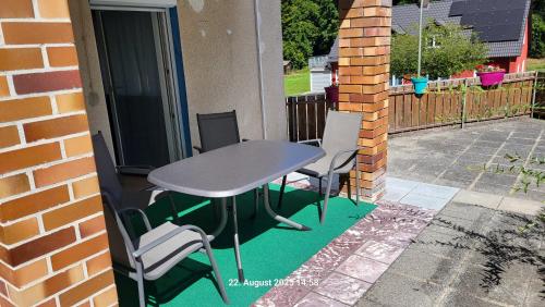 a table and chairs sitting on a patio at Ferienwohnung Mein Zuhause in Pottenstein