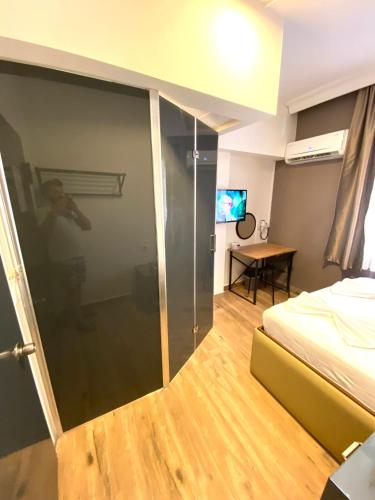 a bedroom with a glass door with a bed and a table at Turunç Hotel ANTALYA in Antalya