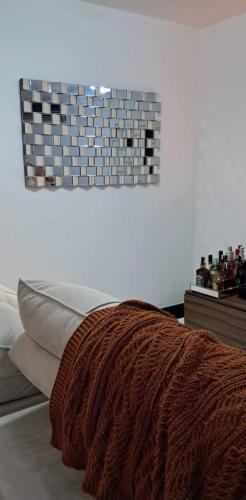 a bedroom with a bed with a brown blanket on it at APARTAMENTO KOBRASOL - Bem localizado in São José