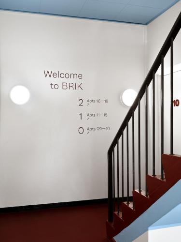 a wall with a welcome to british written on it at BRIK Apartment Hotel in Copenhagen
