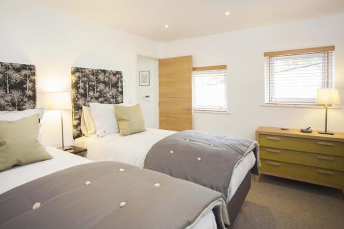 a hotel room with two beds and a dresser and a bedroom at 2 Bed in Bath oc-bhr9 in Bath