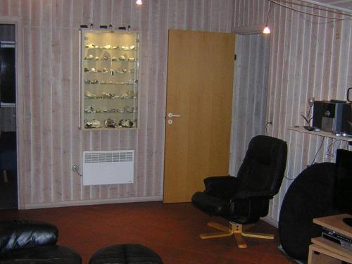 a room with two chairs and a window with wine bottles at Modern Retreat with Spa - By Traum Ferienwohnungen in Nordborg
